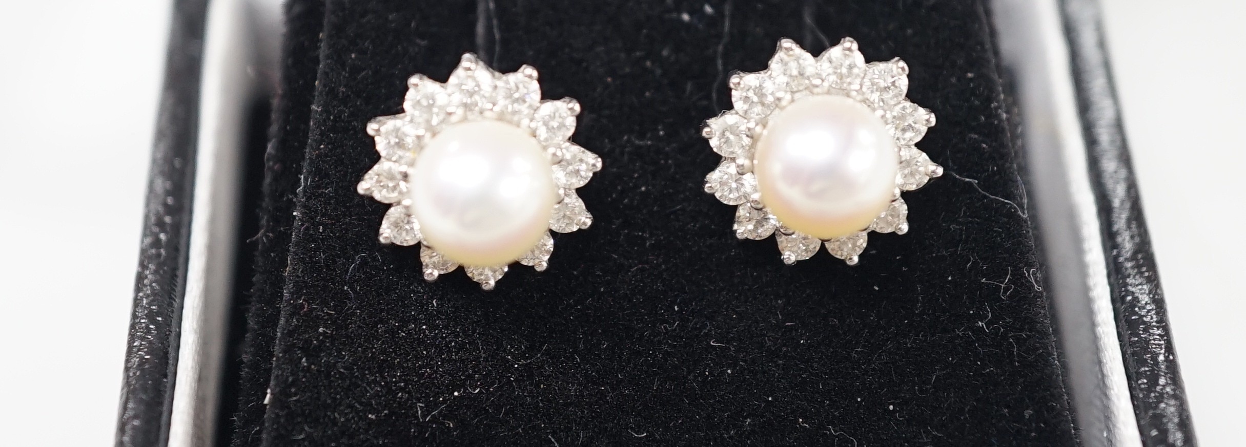 A modern pair of 18ct white gold, cultured pearl and diamond cluster set ear studs, 11mm, gross weight 3 grams.